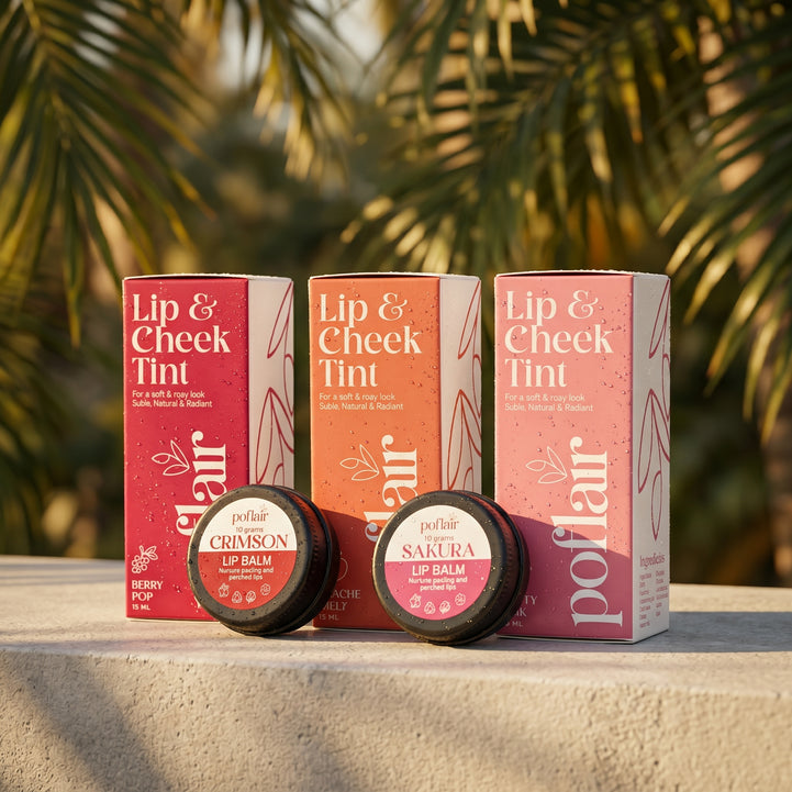Three lip balm containers with their packaging on a surface with a blurred natural background